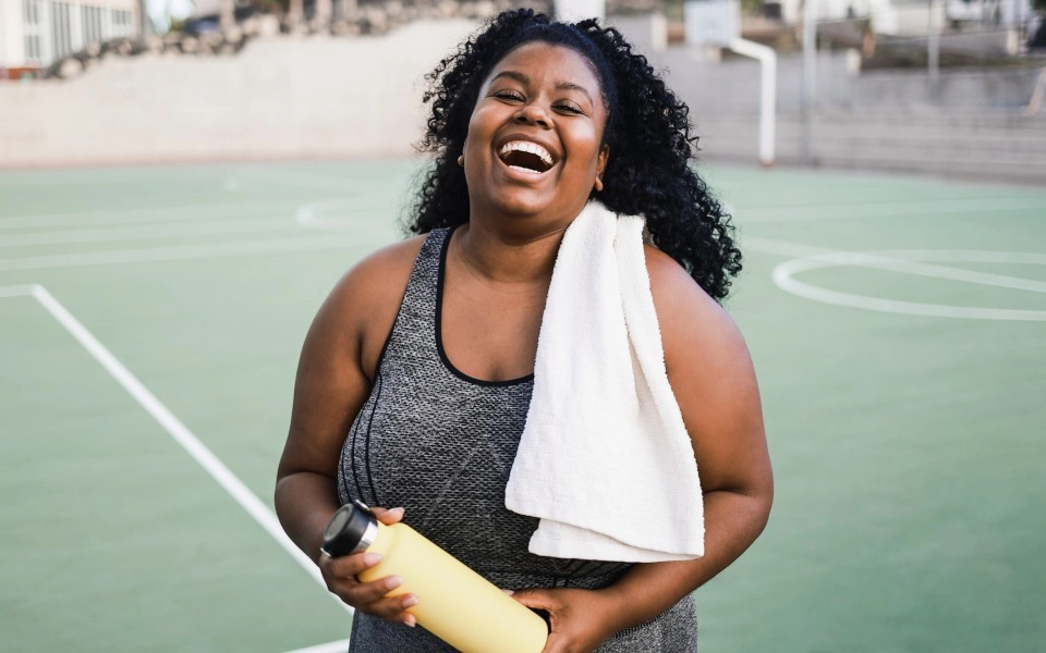 Woman laughing on tennis court