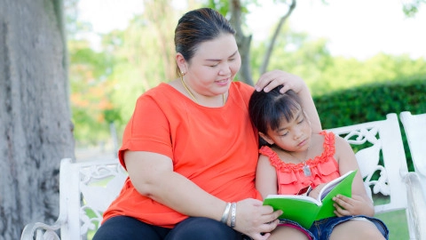 Mother and Daughter Reading Outside
